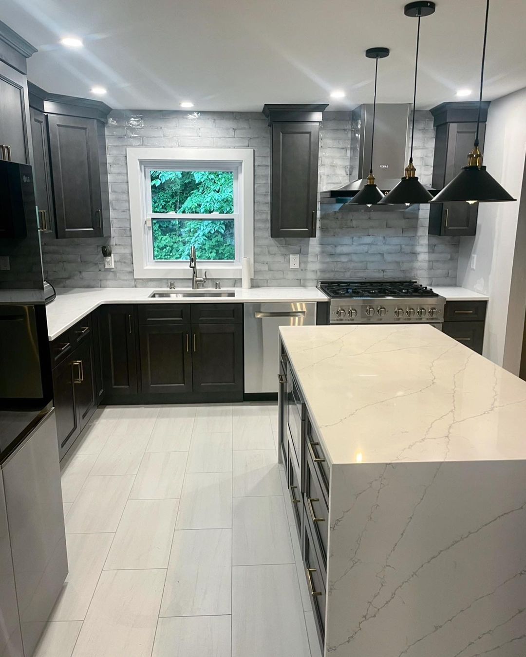 A kitchen with a large island and a stove top oven