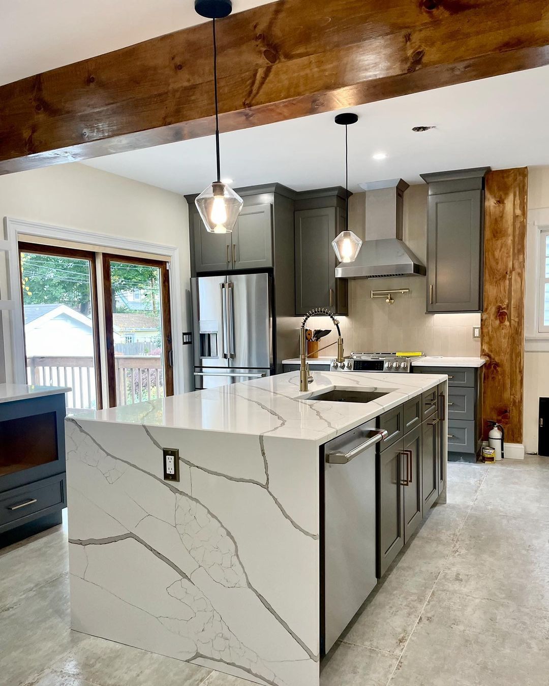 A kitchen with a large island and stainless steel appliances