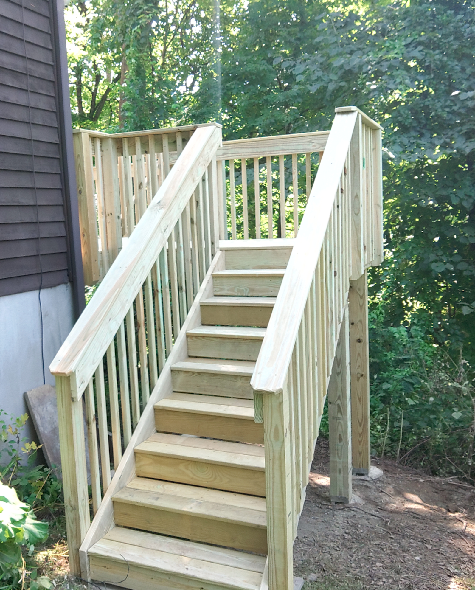 A wooden deck with stairs leading up to it.