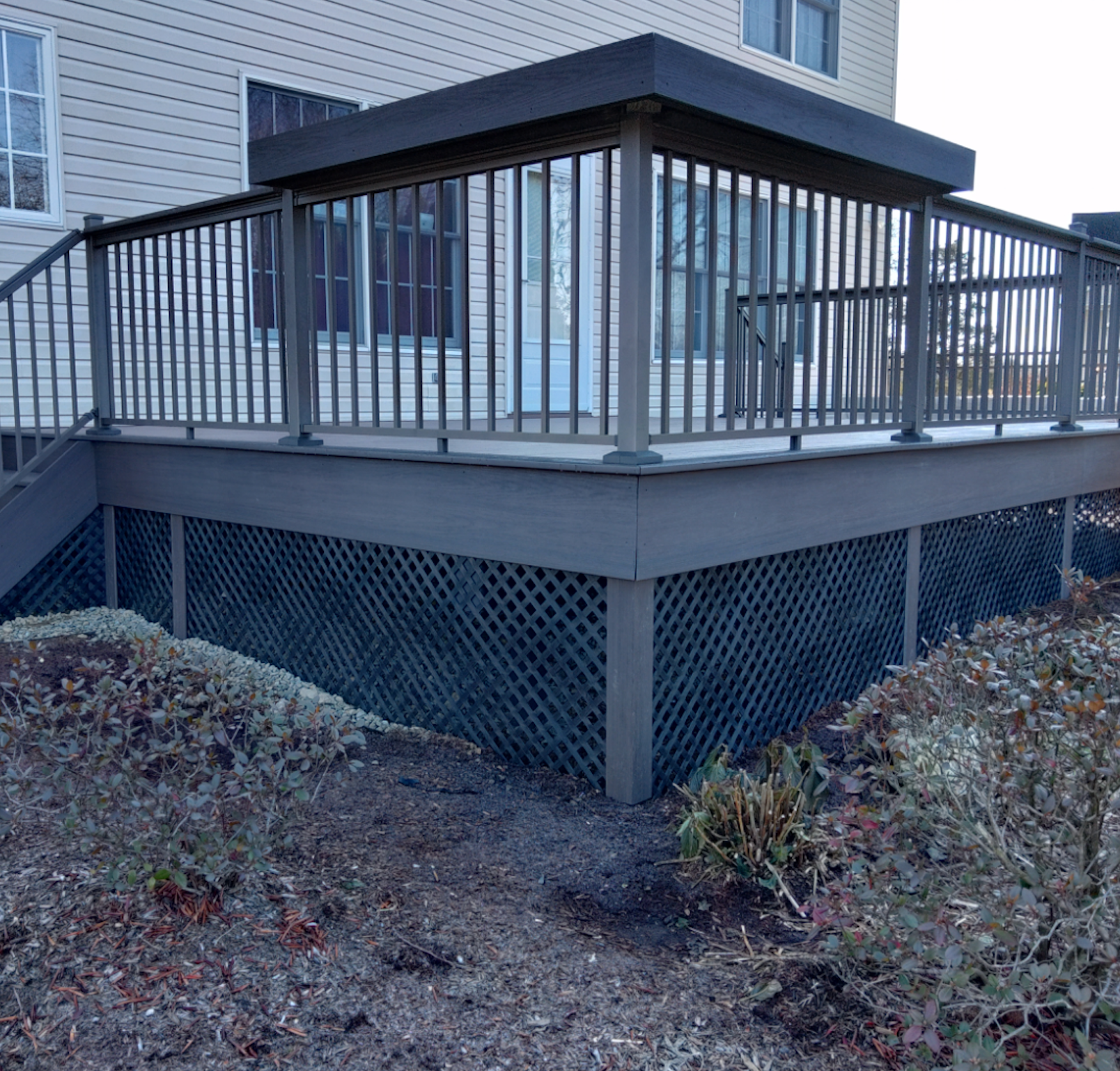 A house with a deck and stairs leading up to it