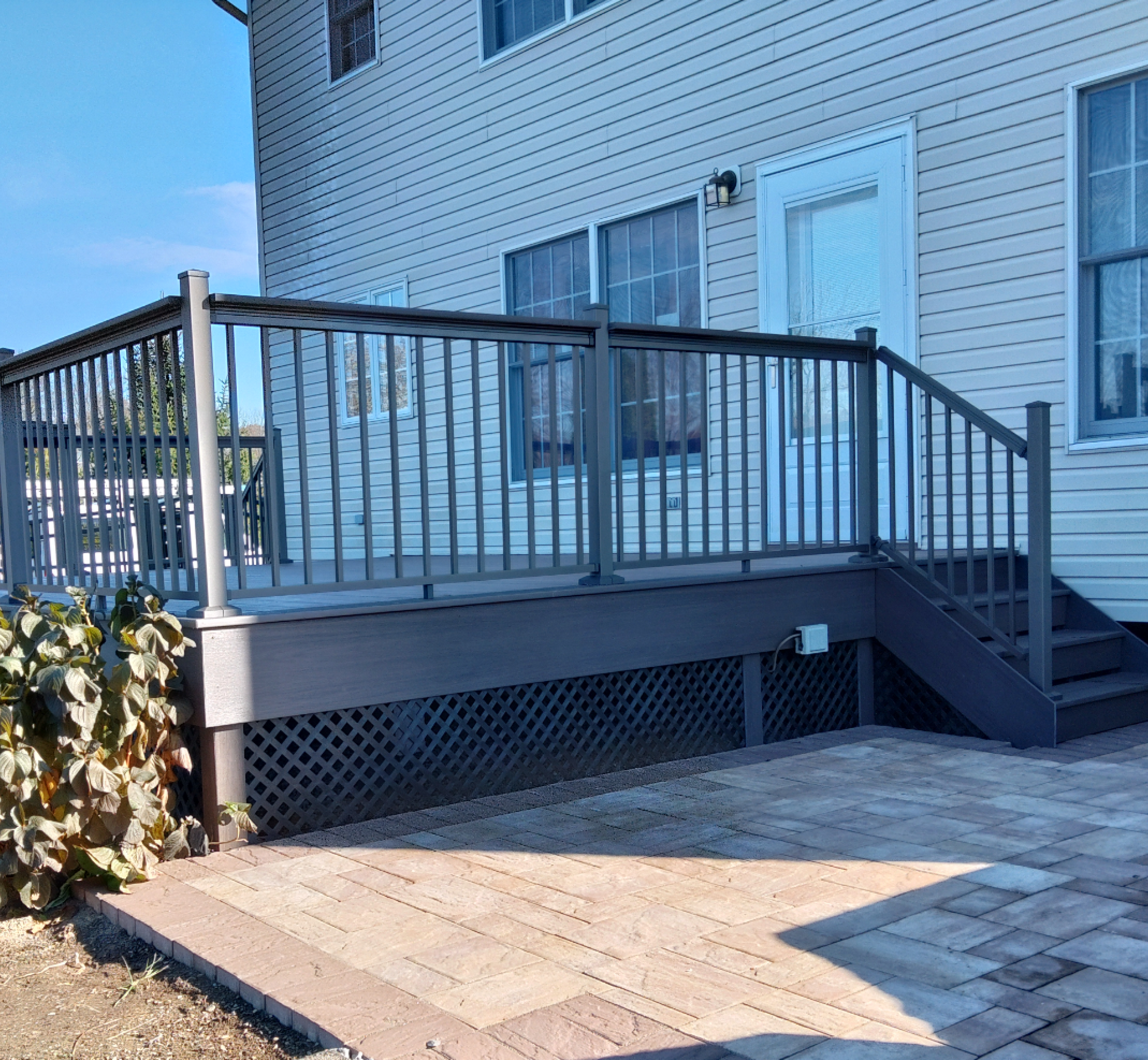 A house with a deck and stairs in front of it