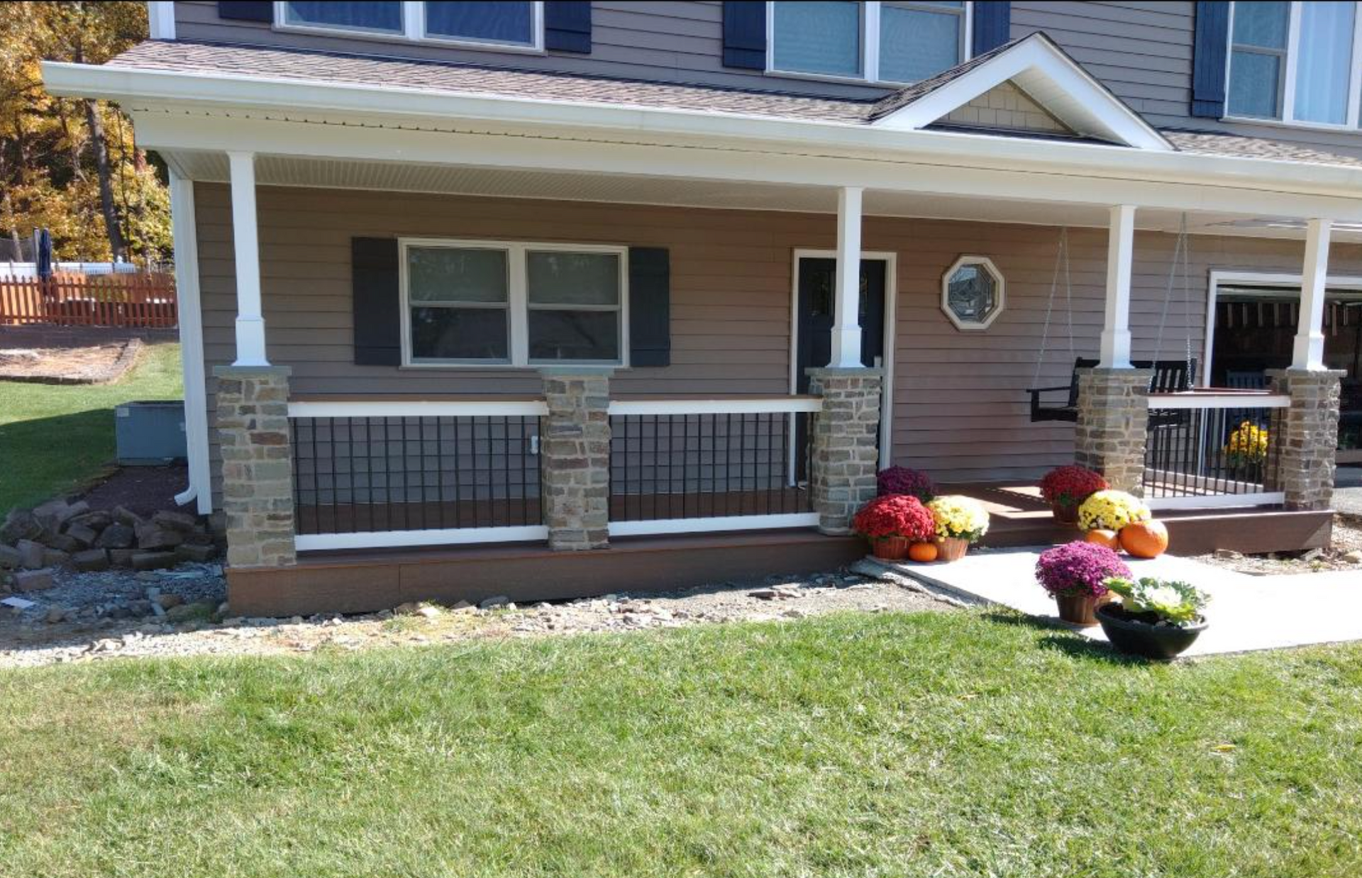 A house with a porch and flowers on it