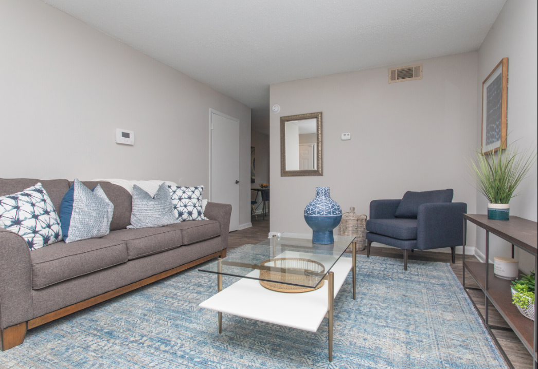 a living room with a couch a chair and a coffee table