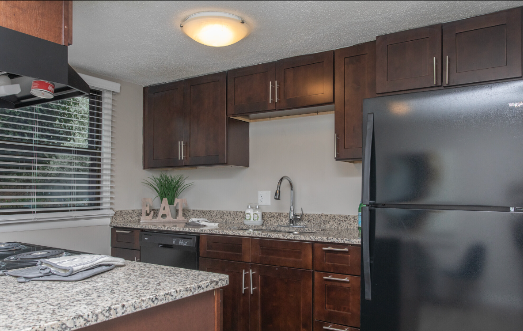 a kitchen with a black whirlpool refrigerator