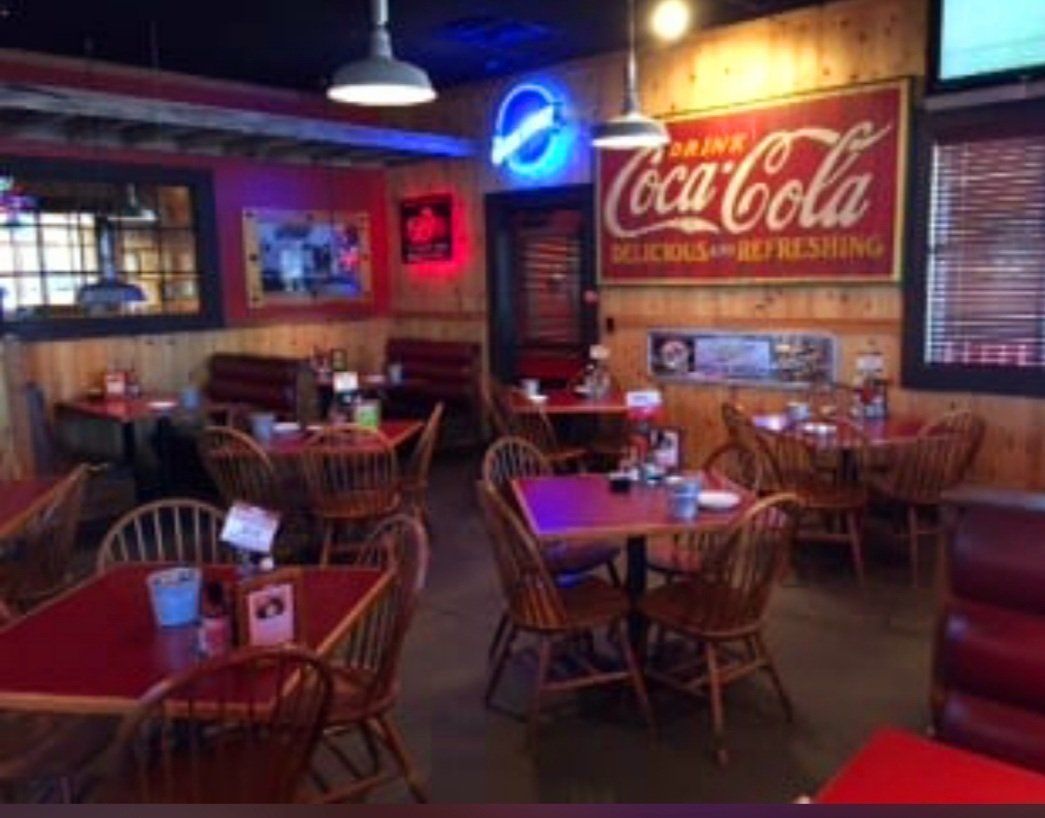 A restaurant with a coca cola sign on the wall