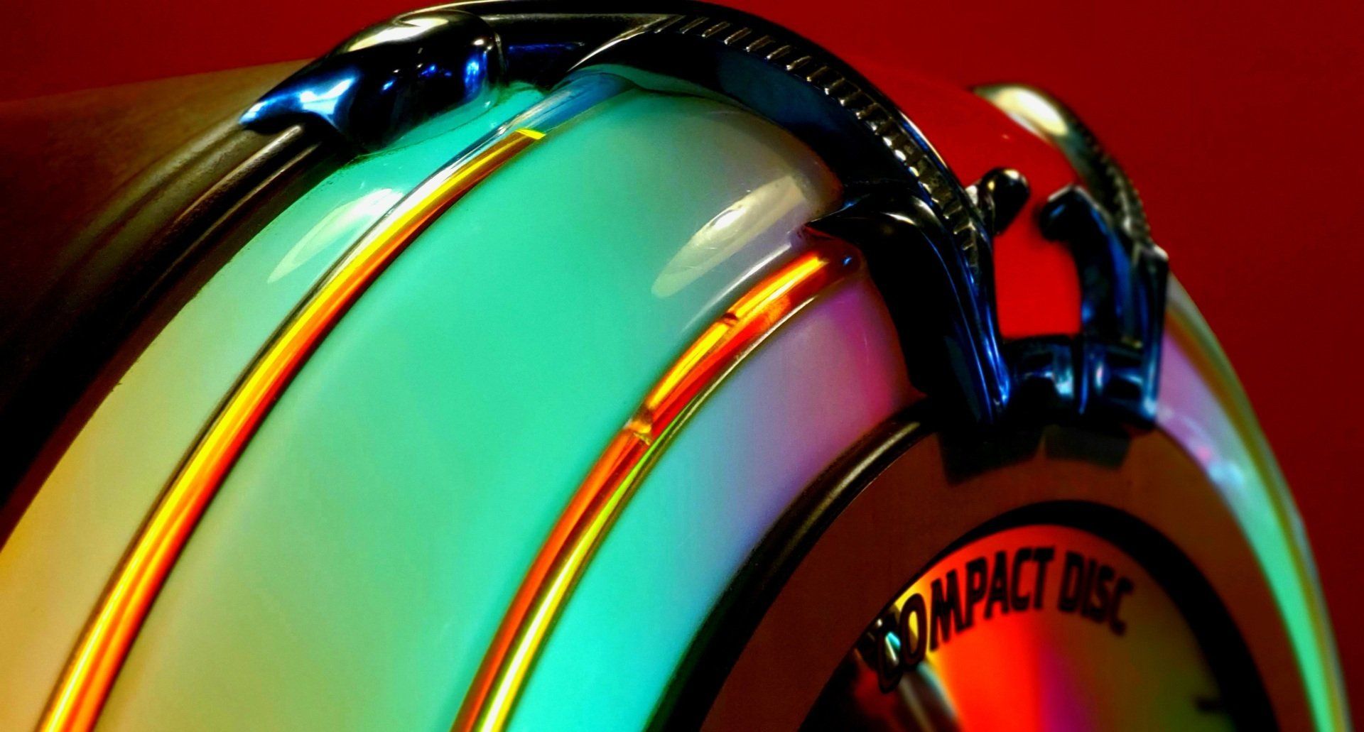 A close up of a compact disc player on a red background