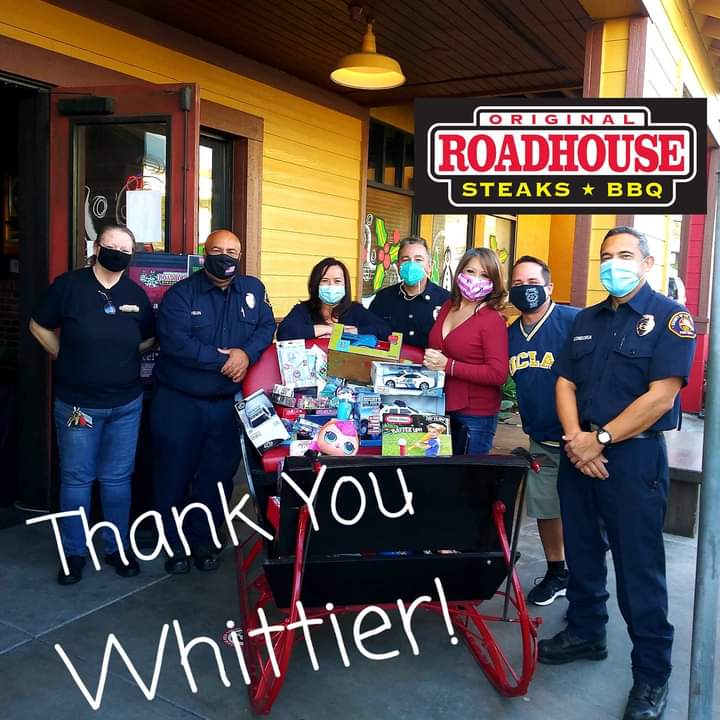 A group of people standing in front of a roadhouse restaurant