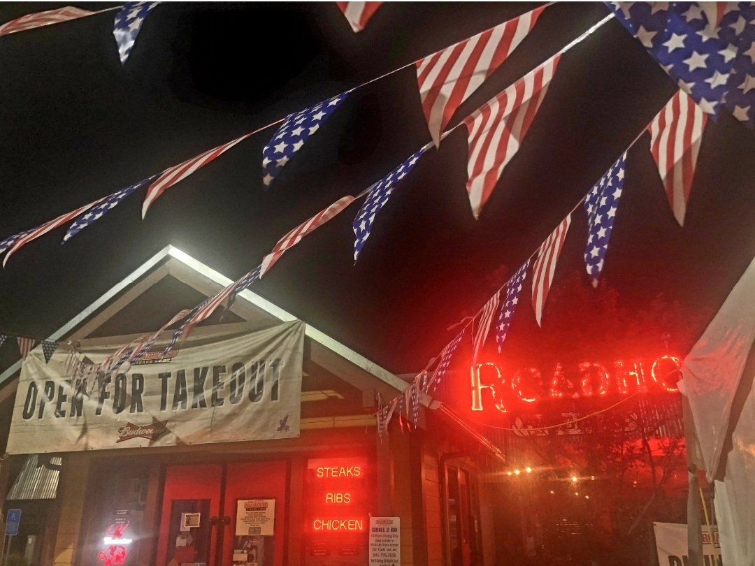 A restaurant with a sign that says open for takeout