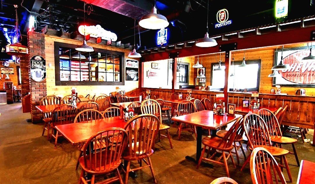 A restaurant with a lot of tables and chairs in it.