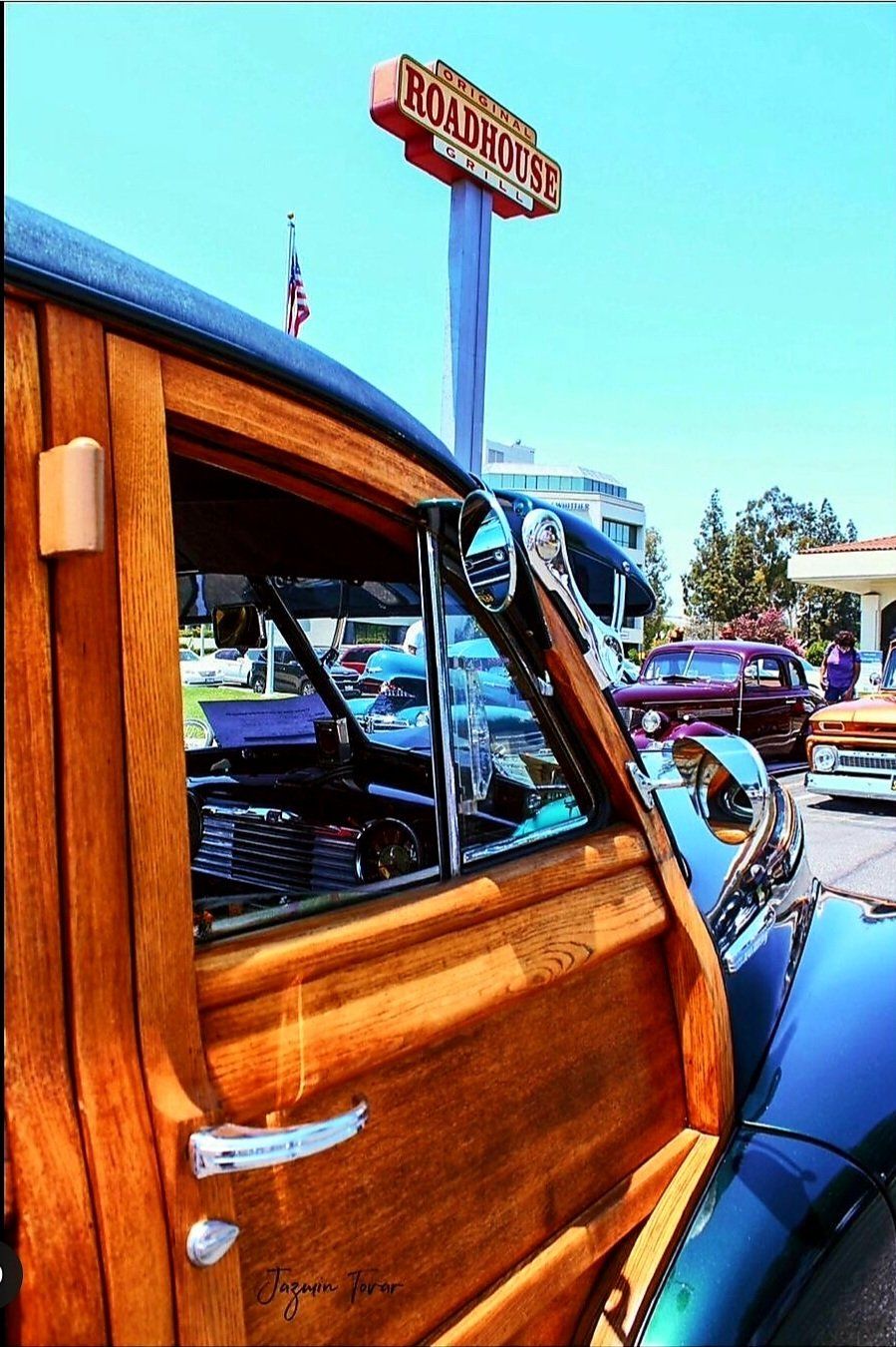 A wooden car is parked in front of a burger king