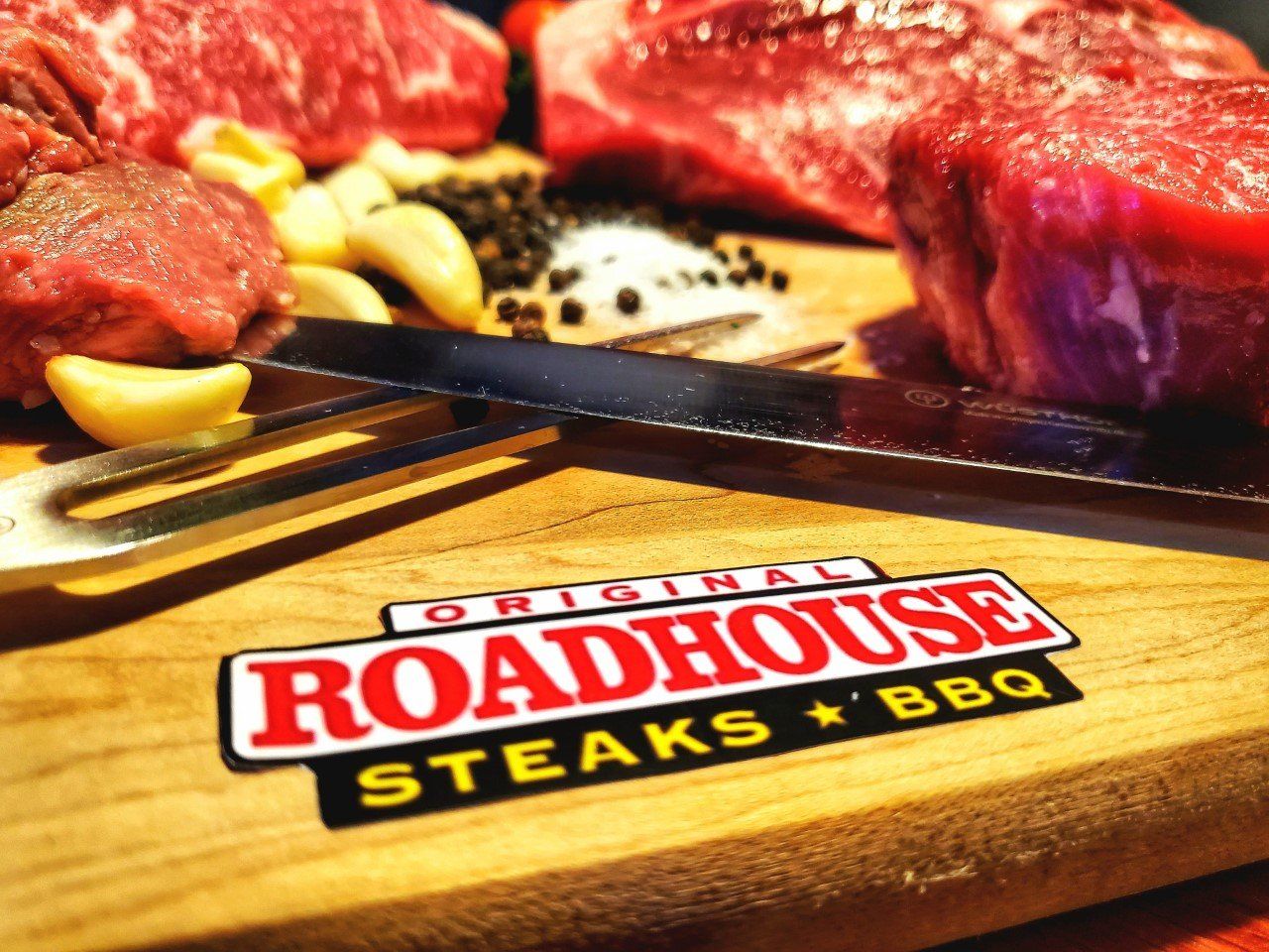 A cutting board with the word roadhouse steaks on it