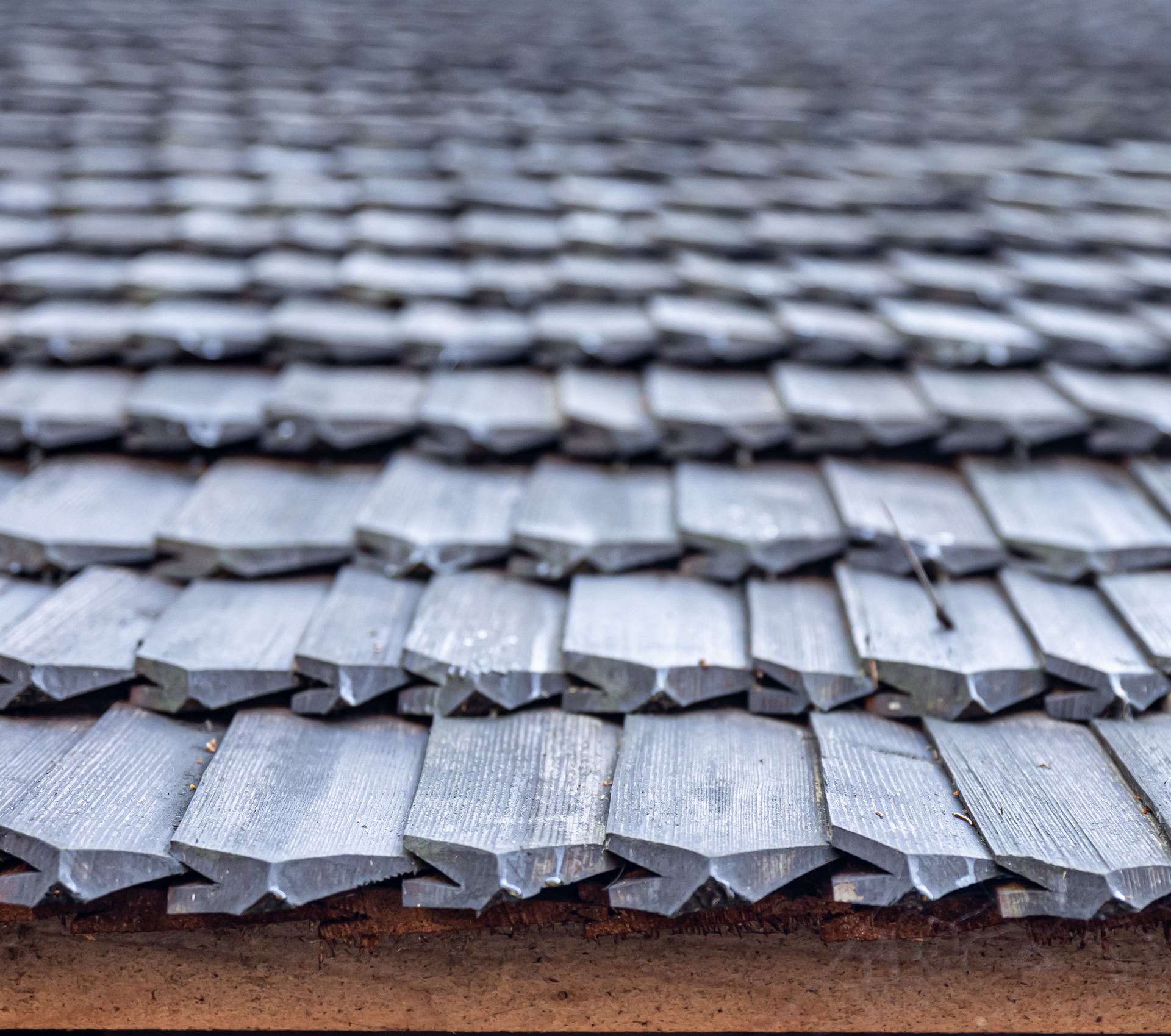 A close up of a wooden roof with shingles.