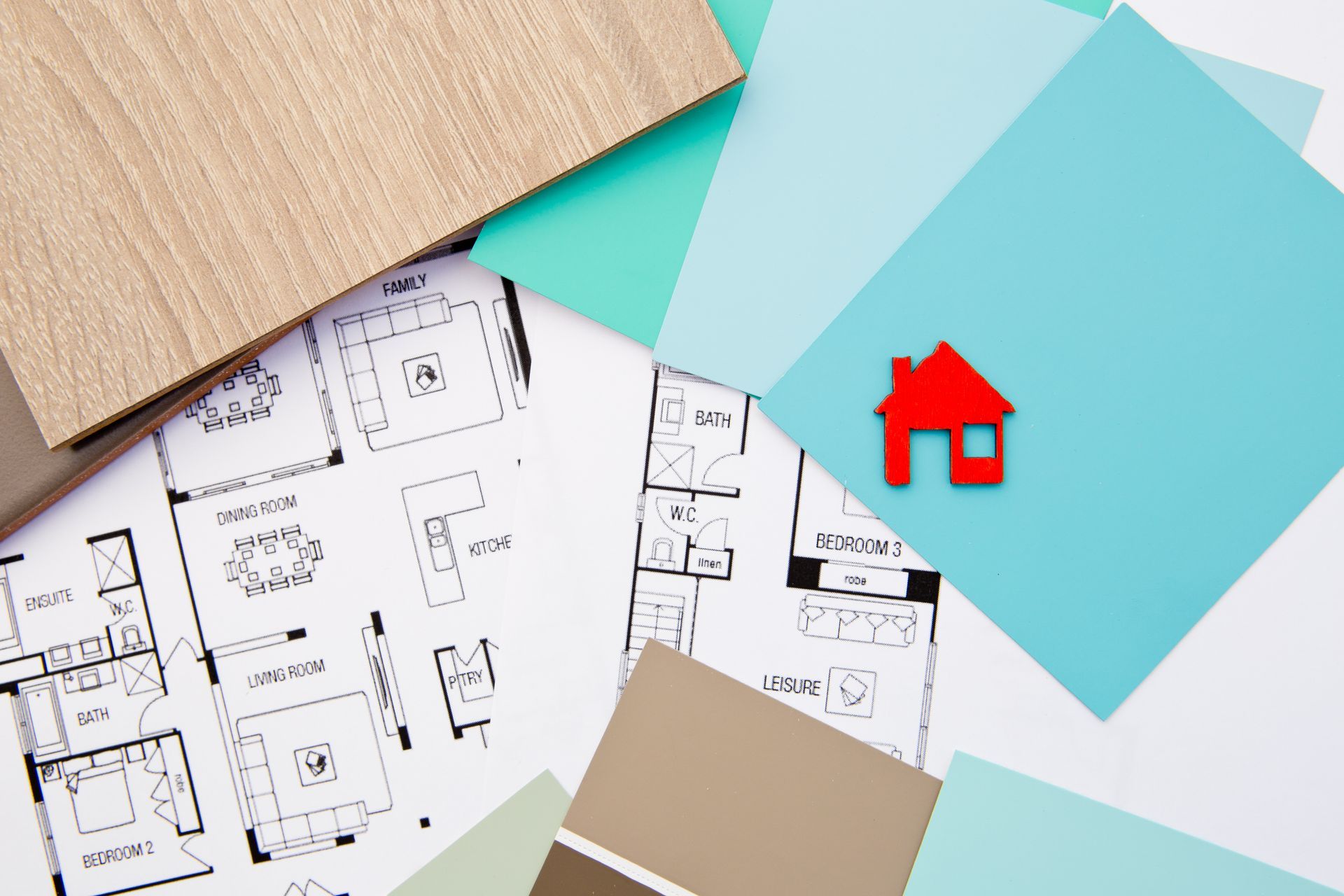 A house icon is sitting on top of a house plan.