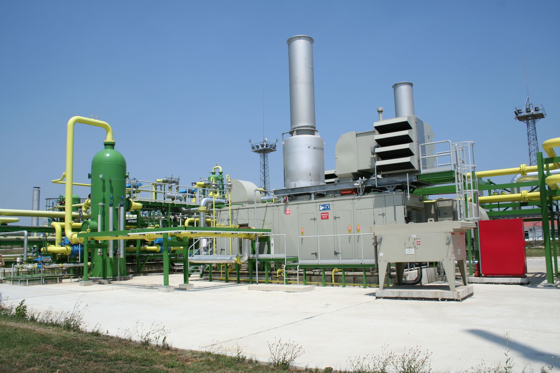 A factory with a lot of pipes and smoke stacks