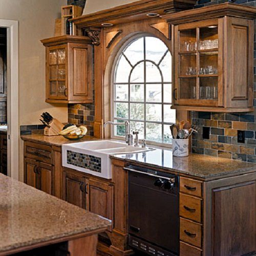 A kitchen with two sinks and a large window