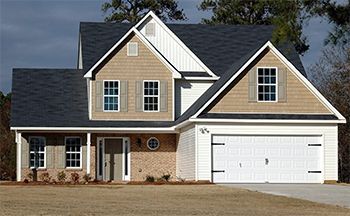 A large brick house with a white garage door