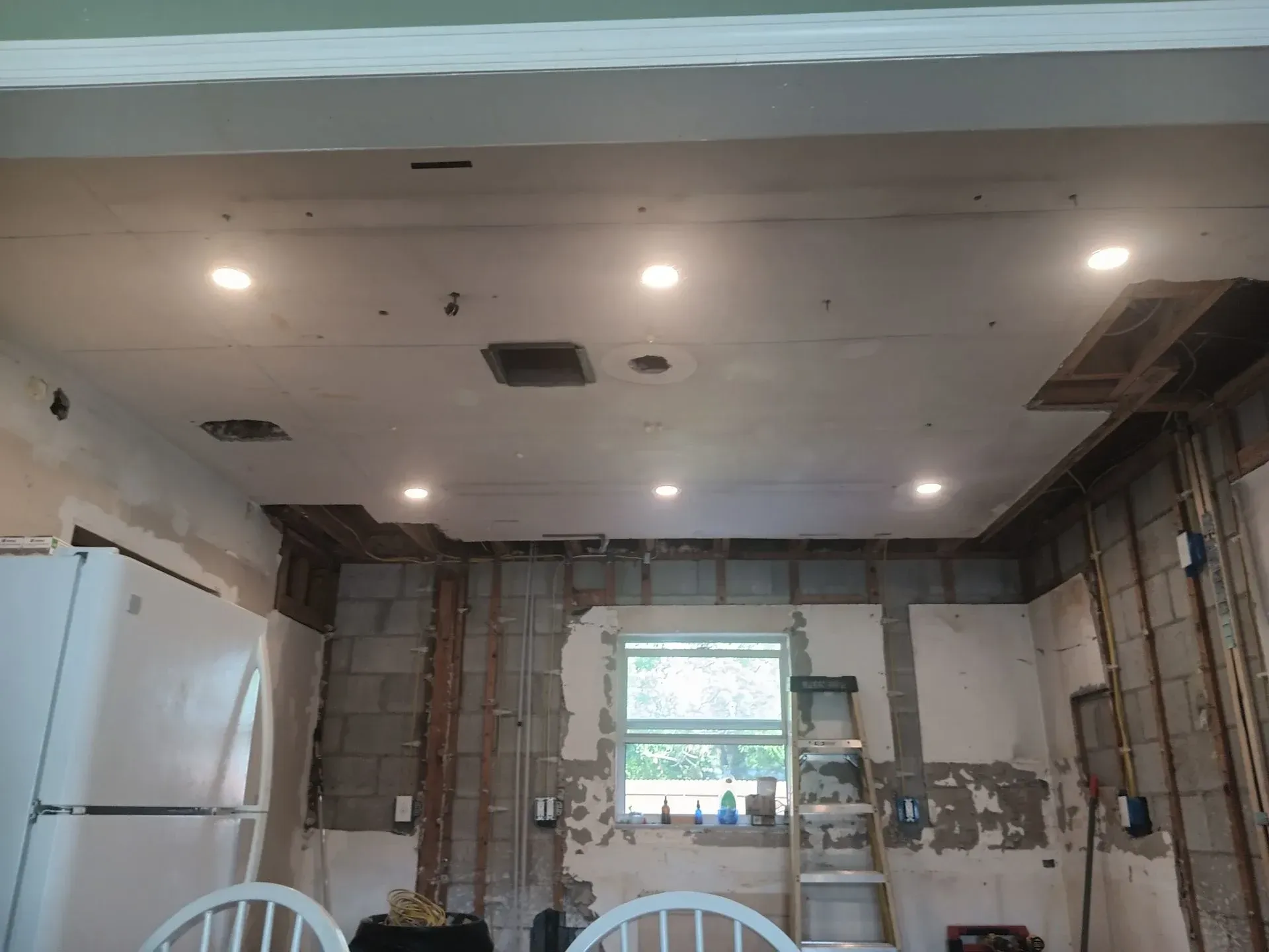 A white truck is parked in a parking lot next to a building.