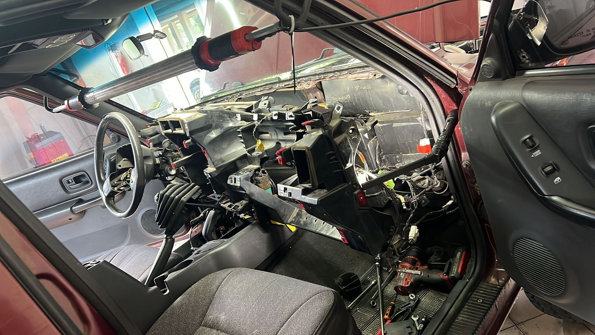 The inside of a car with the dashboard removed.