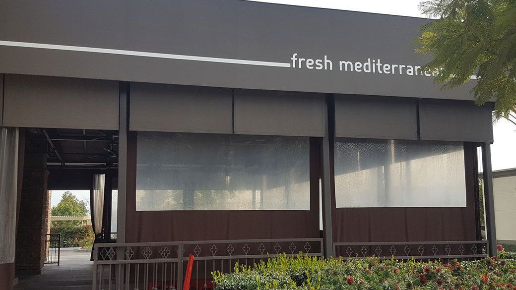 A building with a sign that says fresh mediterranean on it