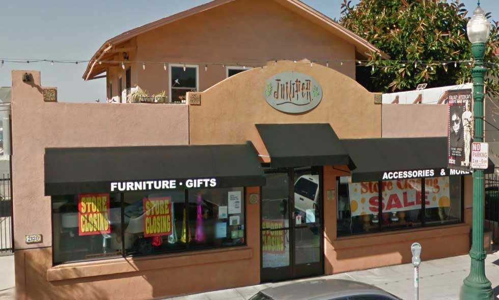 A furniture and gifts store with a dirty awning