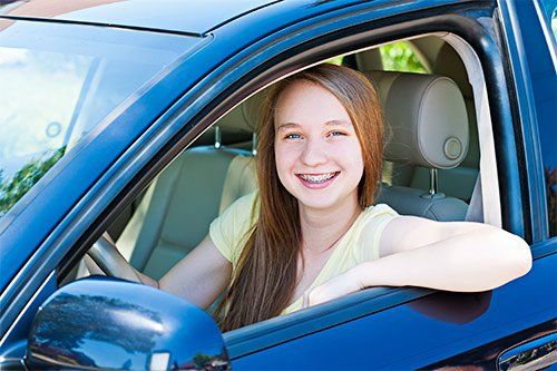Teenage Girl Driving A Car