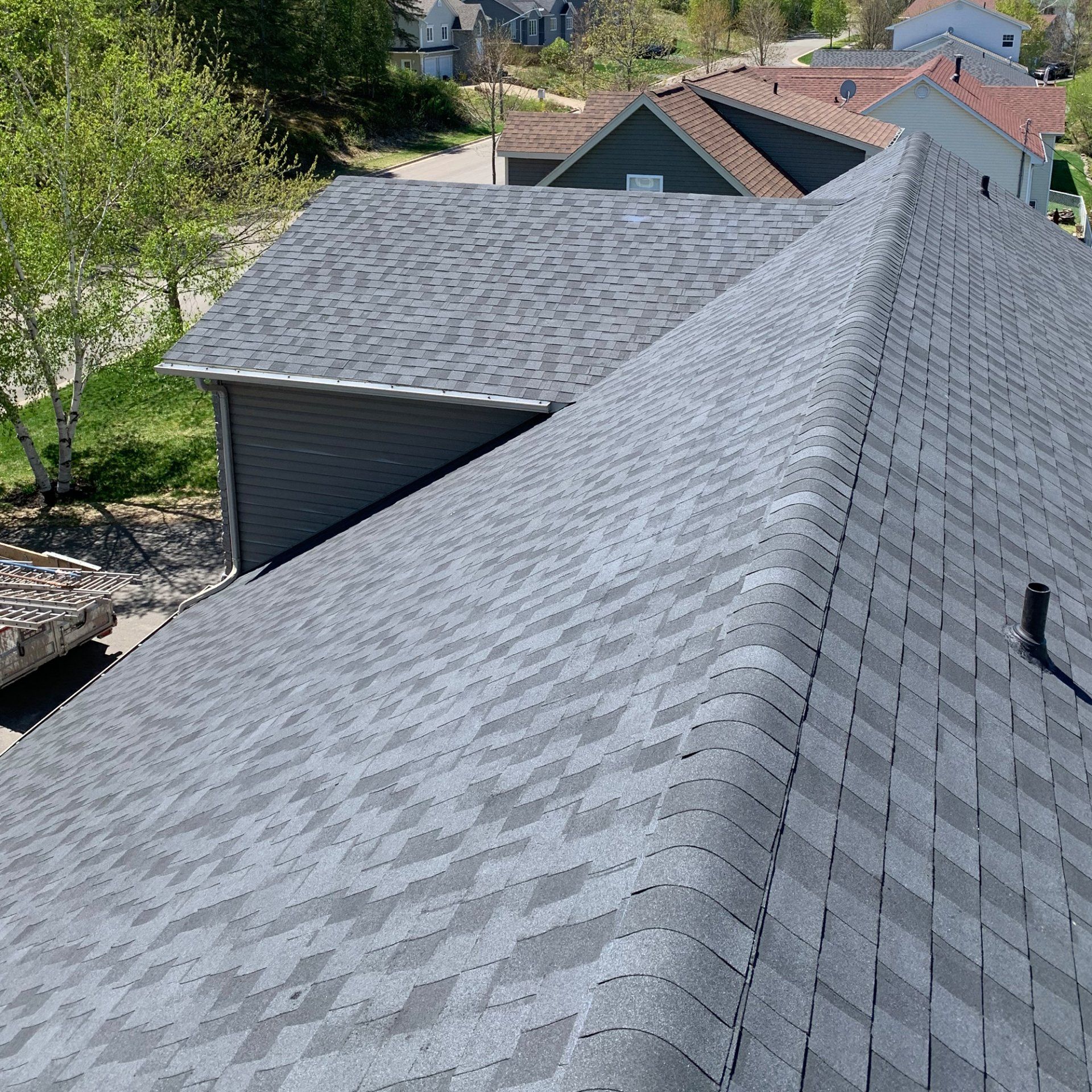 An aerial view of a house with a gray roof.