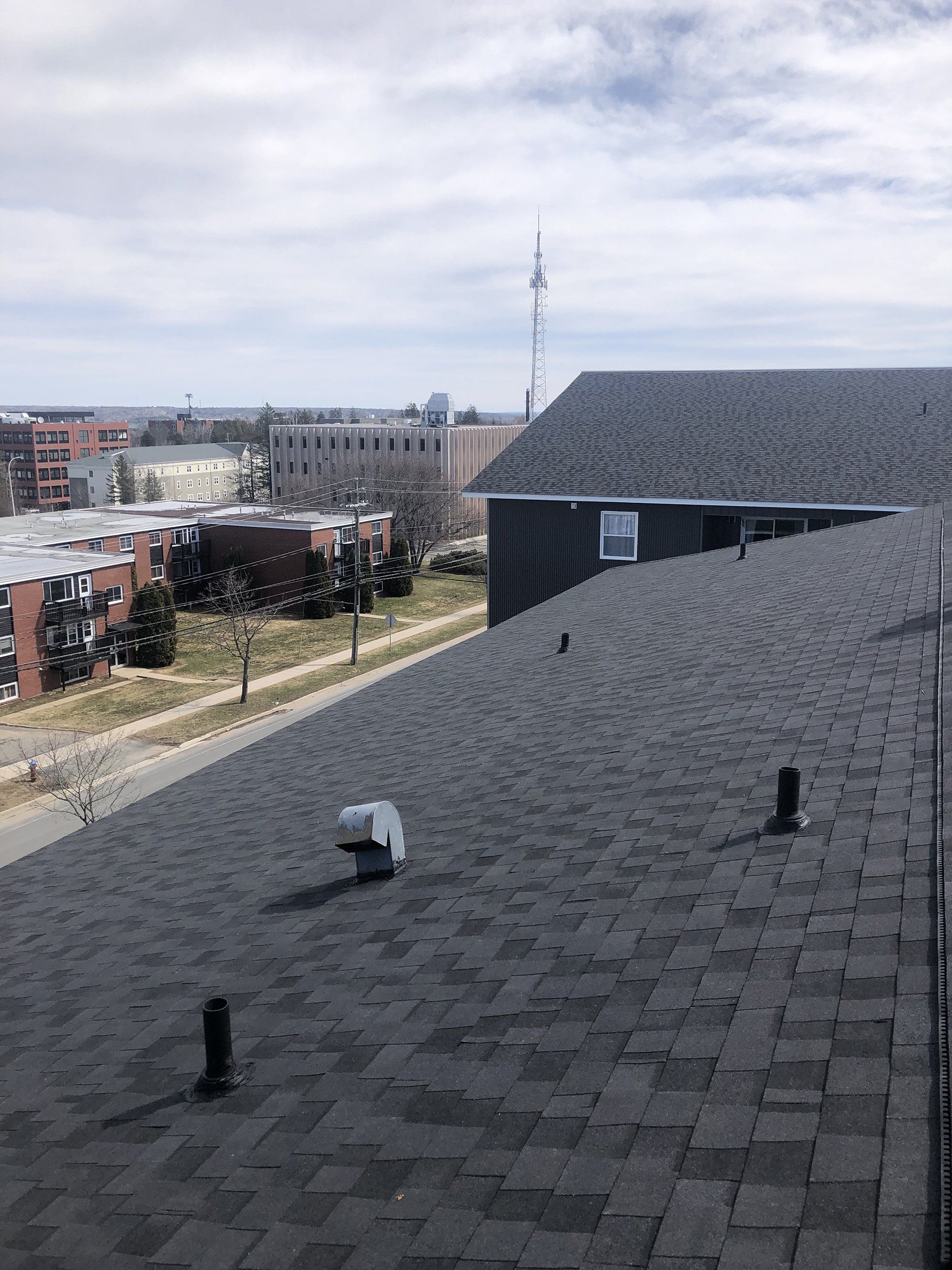 The roof of a building with a view of a city.
