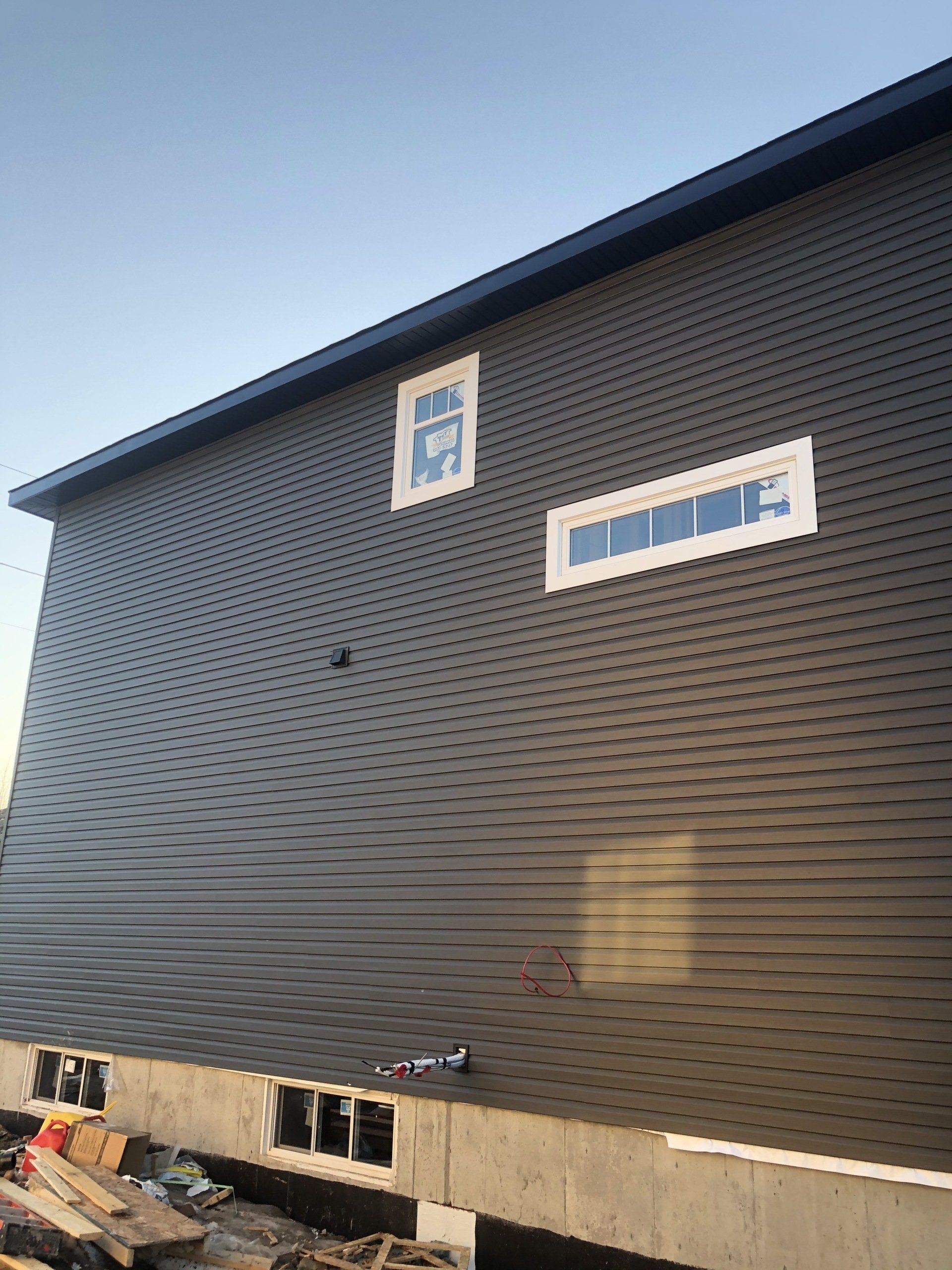 A large building with a blue sky in the background is being built.