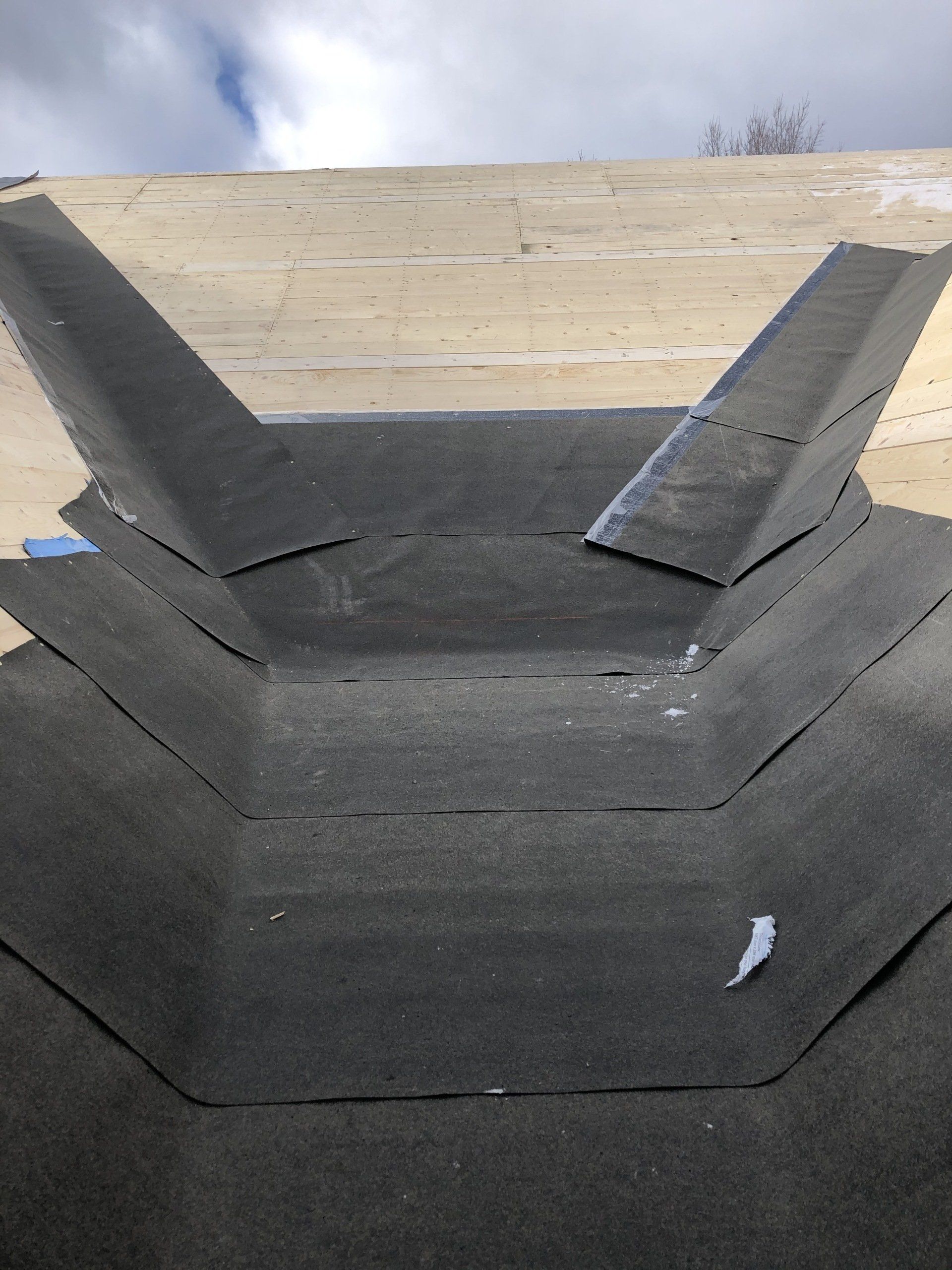 A close up of a concrete wall with a black roof