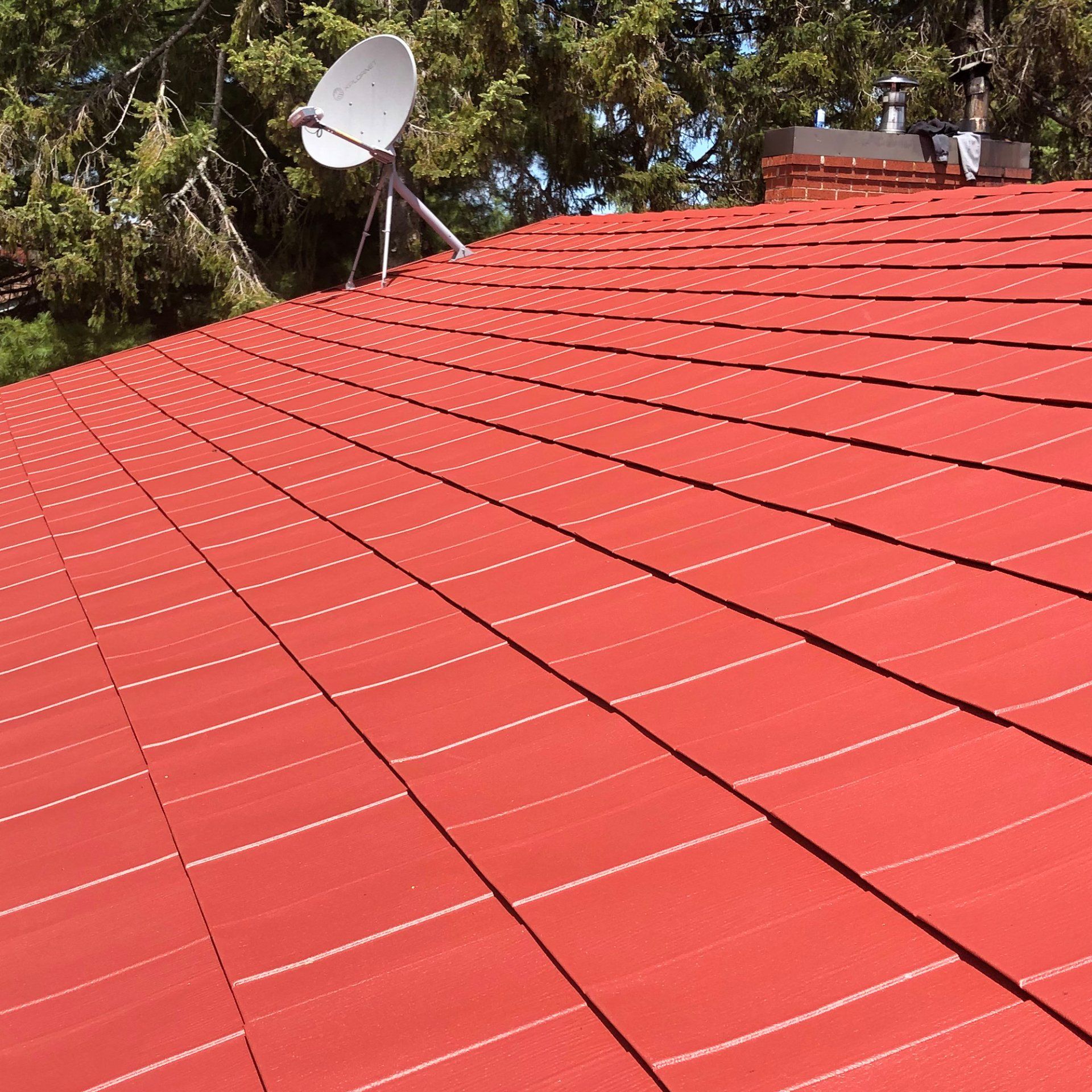A red roof with a satellite dish on it