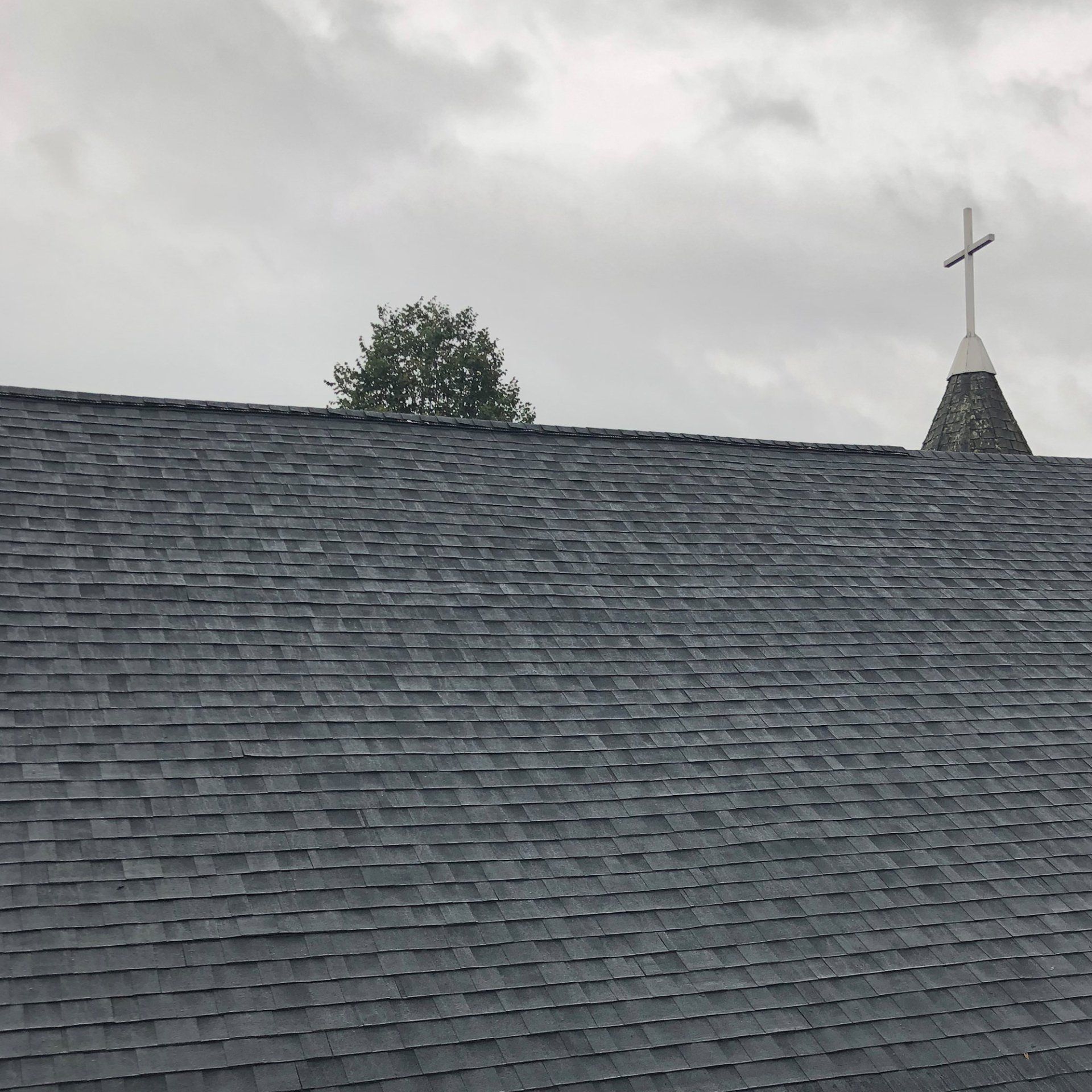 A church roof with a cross on top of it