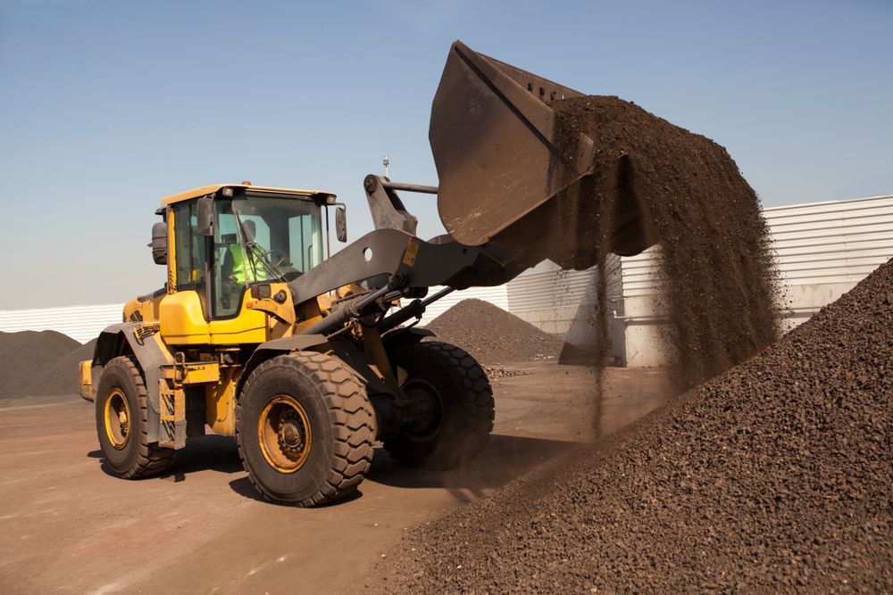 A Bulldozer is Loading Dirt Into a Pile of Dirt — Wilsons Plant in Appin, NSW