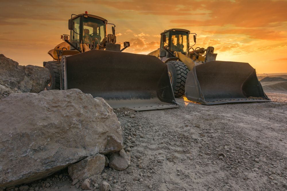 Two Bulldozers Are Working on a Construction Site at Sunset — Wilsons Plant in Ulladulla, NSW