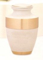 a white urn with a gold rim is sitting on a table .