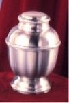 a silver urn is sitting on top of a red table .