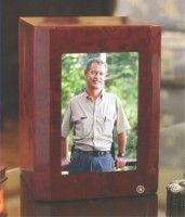 a wooden urn with a picture of a man in it .
