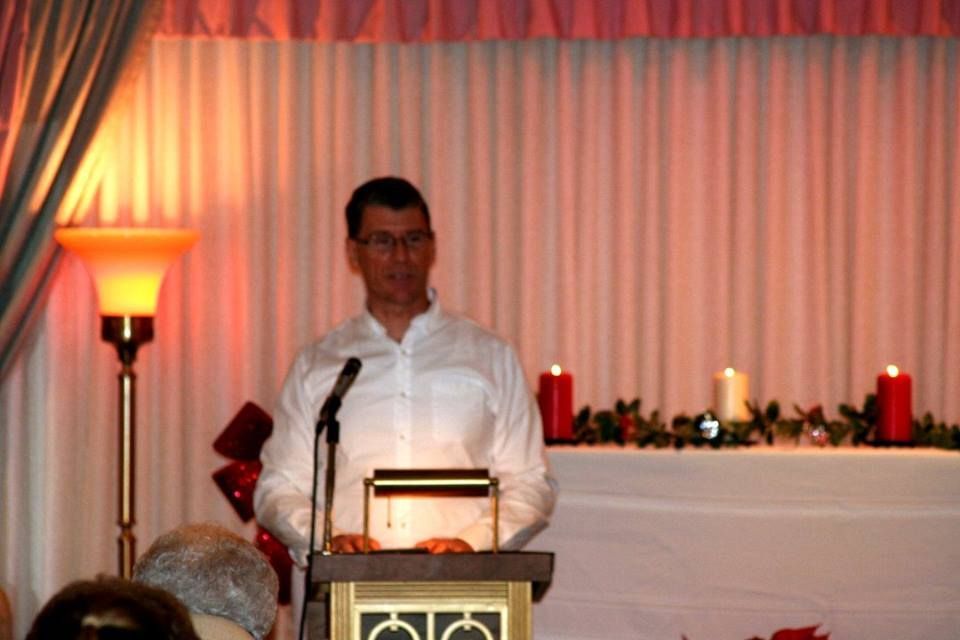 a man is standing at a podium giving a speech