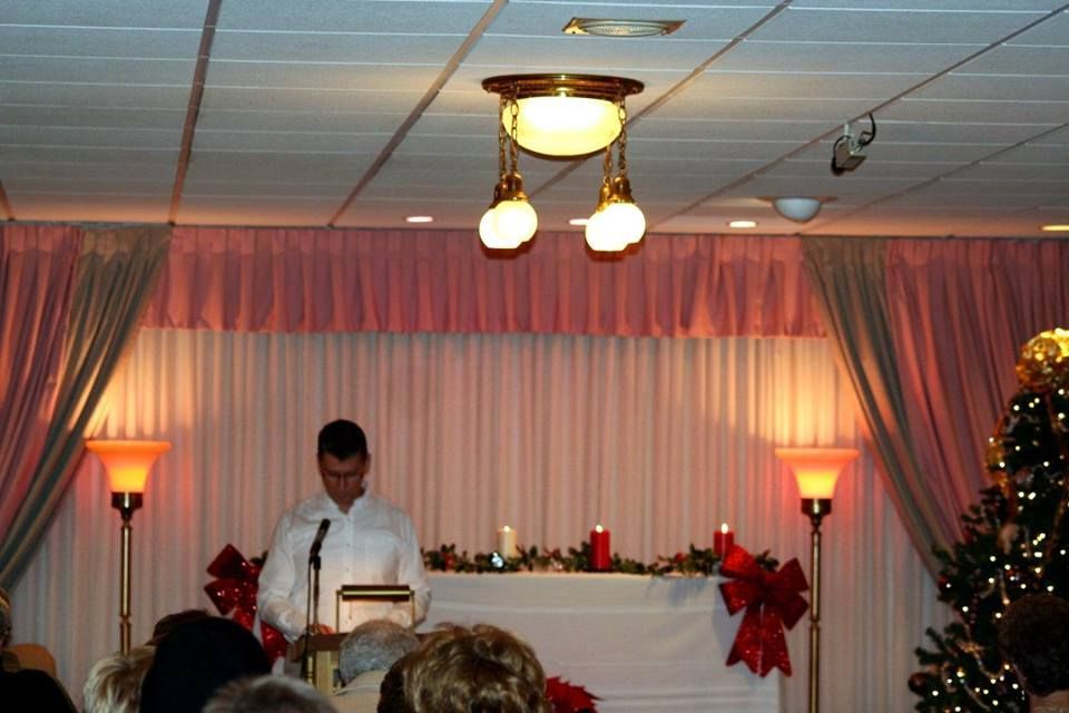 a man stands at a podium in front of a crowd of people