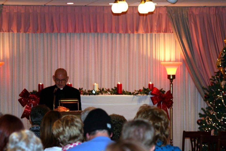 a man is giving a speech in front of a crowd of people