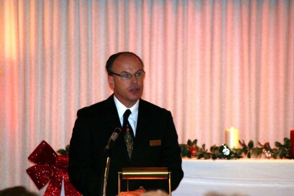 a man in a suit and tie is standing at a podium giving a speech