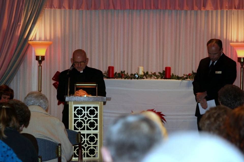 a man stands at a podium in front of a crowd of people