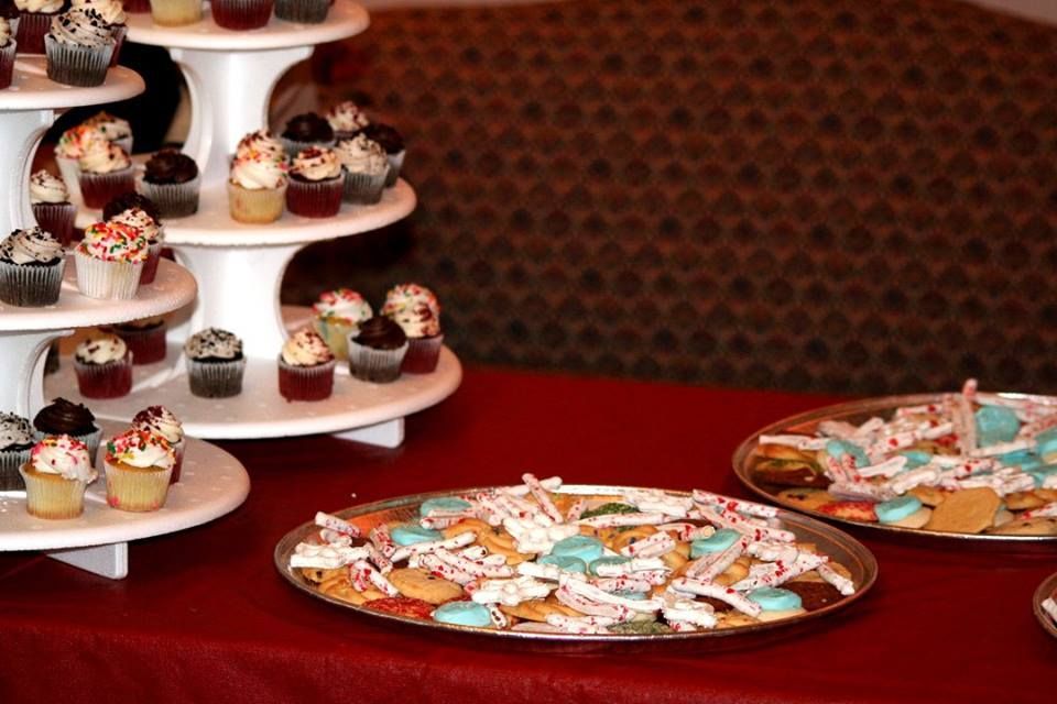 a table with cupcakes and cookies on it