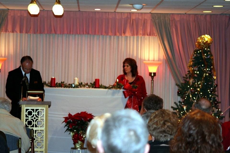 a man and a woman stand at a podium in front of a crowd