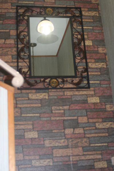 a brick wall with a mirror on it