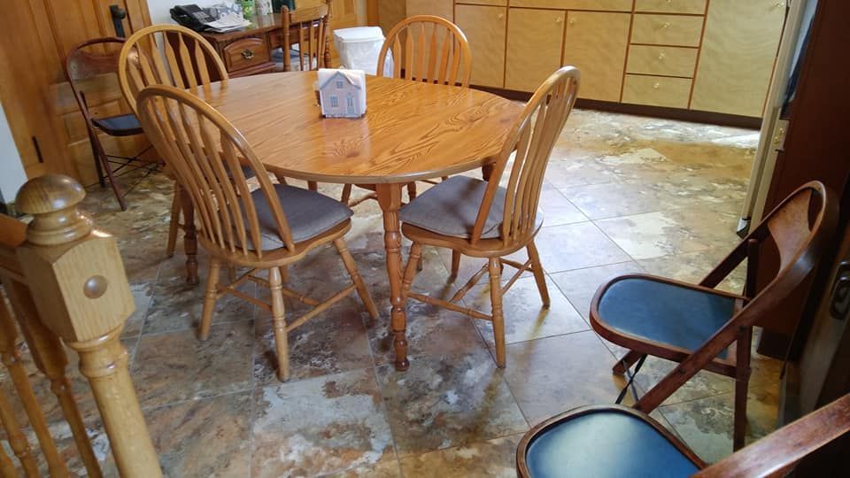 a kitchen with a table and chairs in it