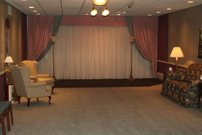 a living room with a couch , chairs and lamps