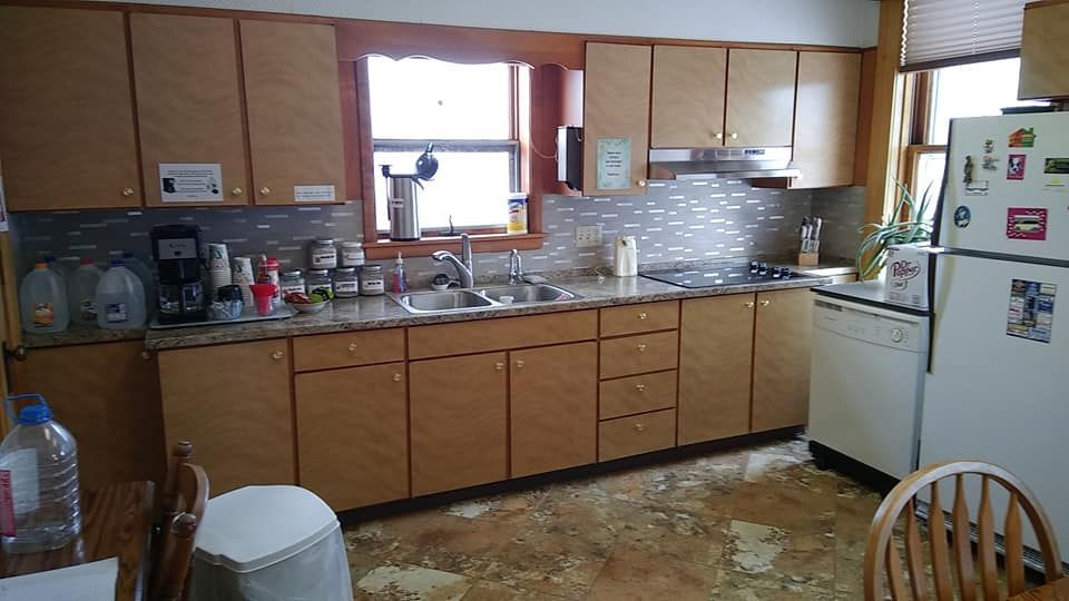 a kitchen with wooden cabinets and a white refrigerator