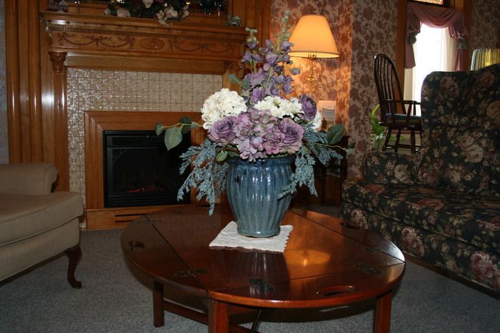 a vase of flowers sits on a coffee table in a living room