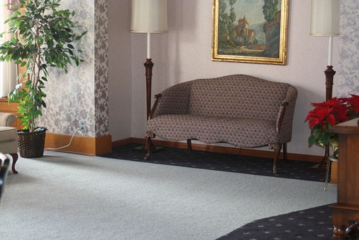 a living room with a couch and a picture on the wall