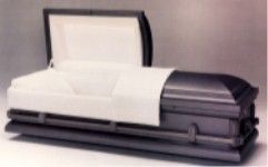 a black and white casket with the lid open is sitting on a table .